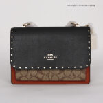 coach klare in signature canvas with rivets