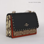 coach klare in signature canvas with rivets