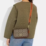 coach logan messenger in signature canvas